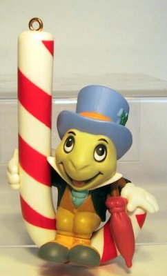 Jiminy Cricket sitting on a candy cane ornament (Grolier)