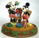 Minnie Mouse holds mistletoe over Mickey Mouse Christmas Disney figure