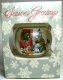 Season's Greetings decorating Christmas tree glass ball ornament