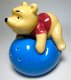 Winnie the Pooh laying on top of balloon salt and pepper shaker set